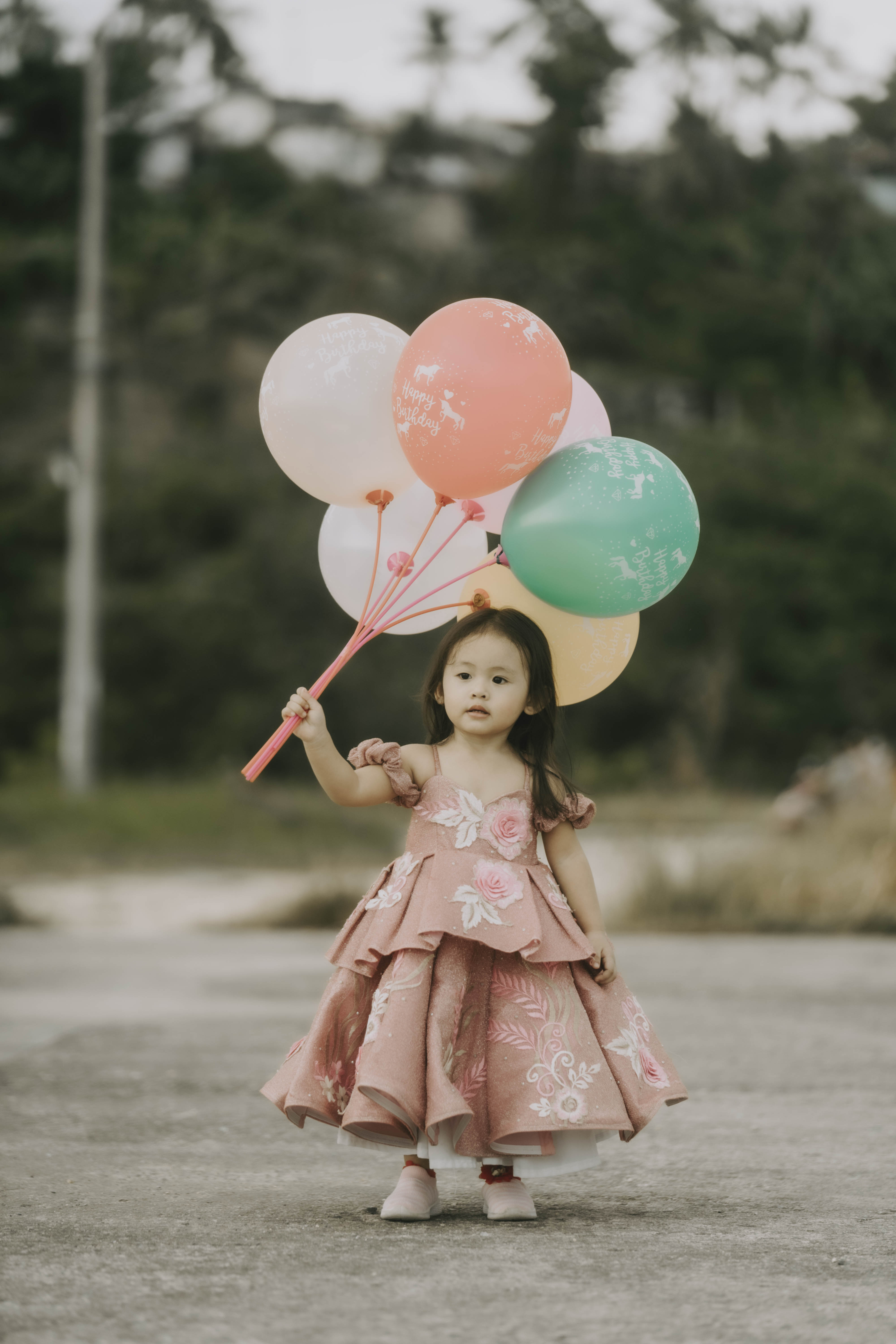 Toddler with bunch of balloons